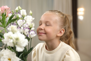 девочка нюхает цветы